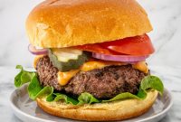 Juicy Mozzarella-Stuffed Burgers with Crispy Basil and Tomato