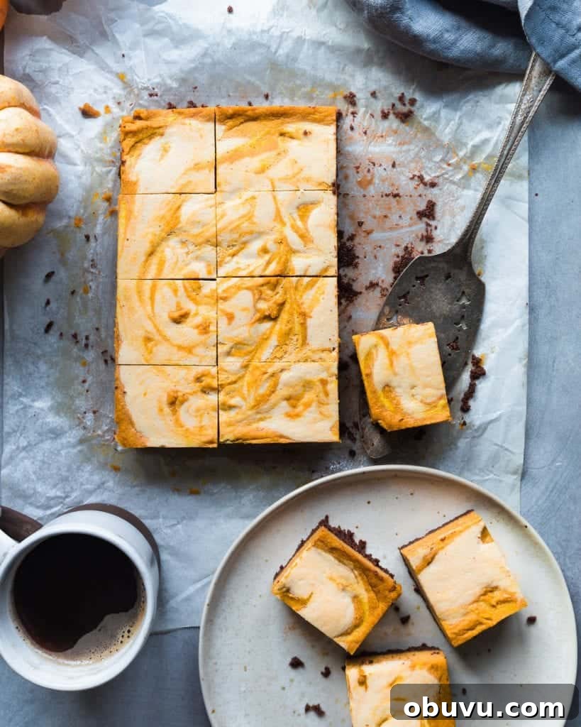 Vegan Baked Pumpkin Cheesecake Bars — Creamy Fall Dessert 3 Plate of cheesecake bars next to the rest of the cheesecake on parchment paper.