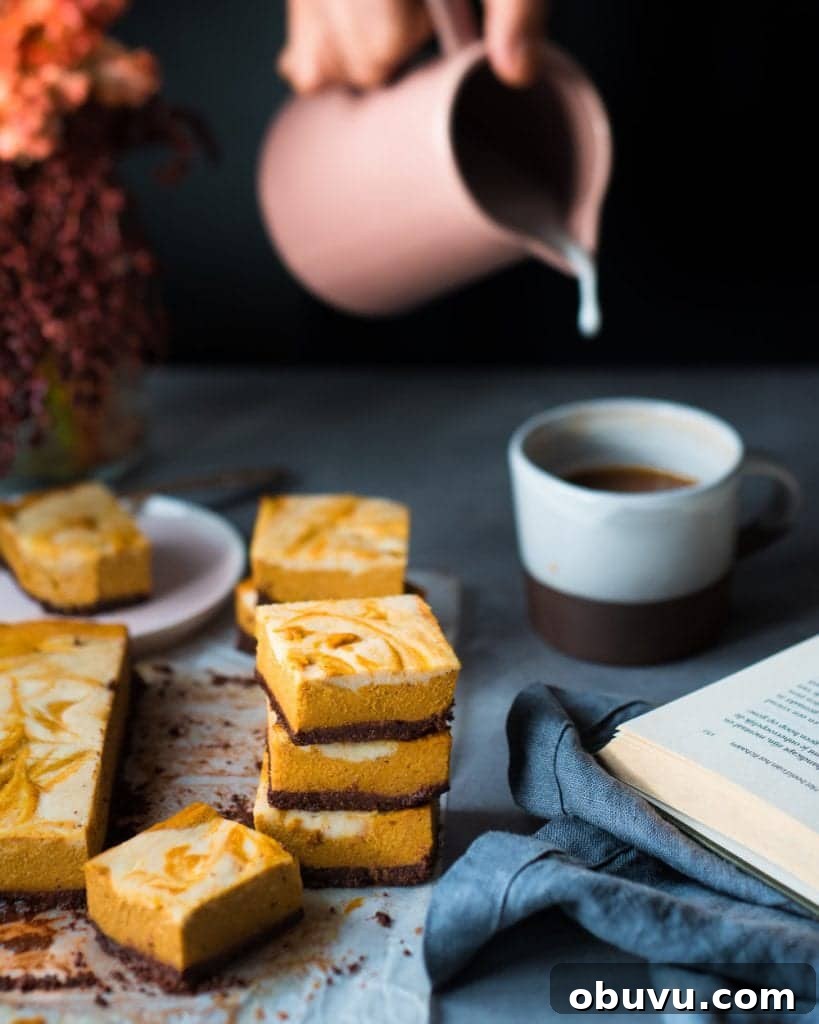 Vegan Baked Pumpkin Cheesecake Bars — Creamy Fall Dessert 5 Woman pouring vegan milk into a cup of coffee next to cheesecake bars on a table.