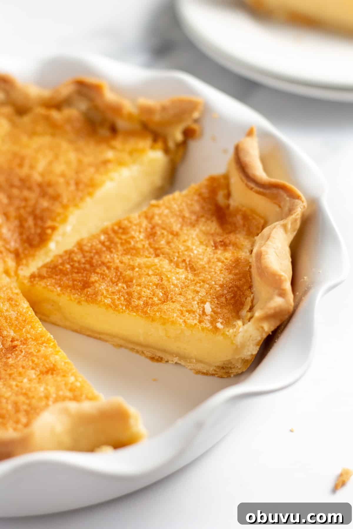 slice of buttermilk pie with homemade pie crust.