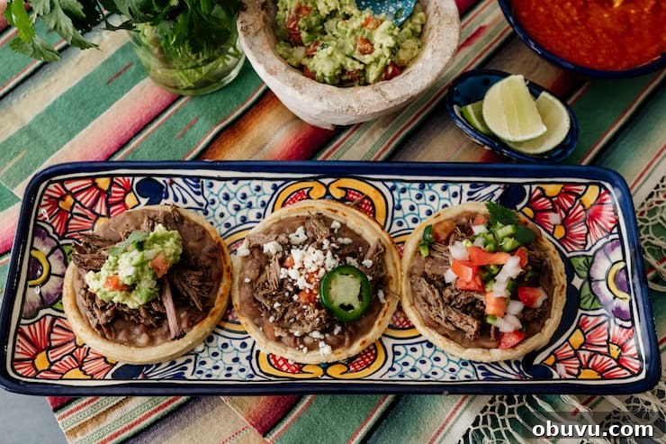 Brisket Sopes: Authentic Mexican Sopes de Carne Deshebrada 11 overhead shot of a horizontal rectangular serving platter with three brisket filled sopes.