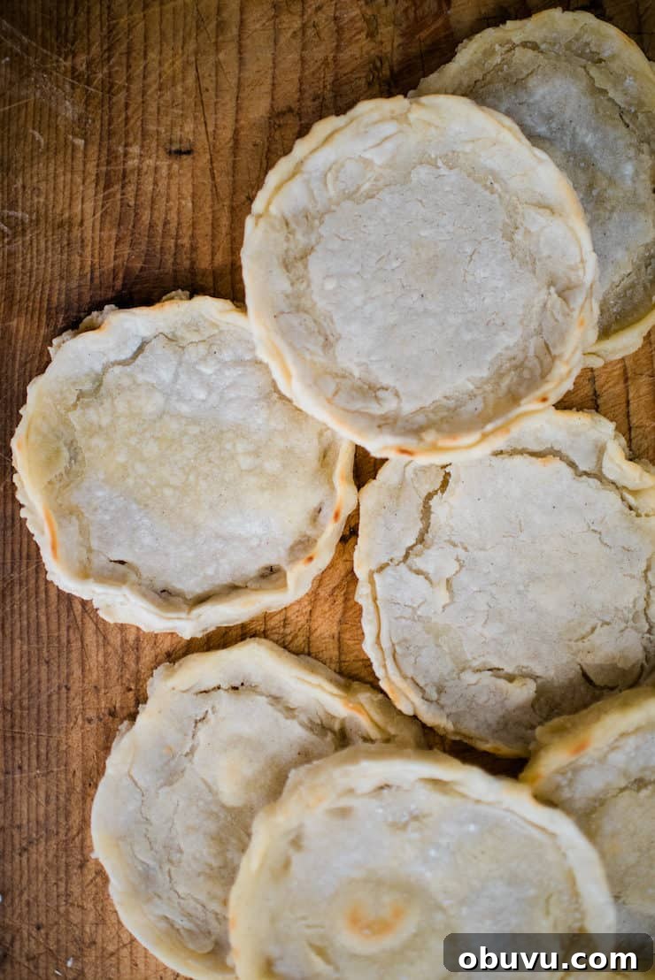 Brisket Sopes: Authentic Mexican Sopes de Carne Deshebrada 5 unfilled mexican sopes shells on a wooden table.