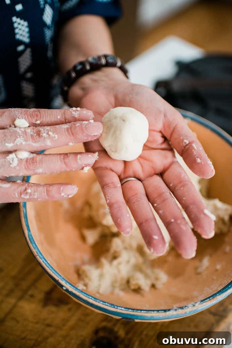 Brisket Sopes: Authentic Mexican Sopes de Carne Deshebrada 6 how to make sopes - showing two hands rolling dough into a ball.