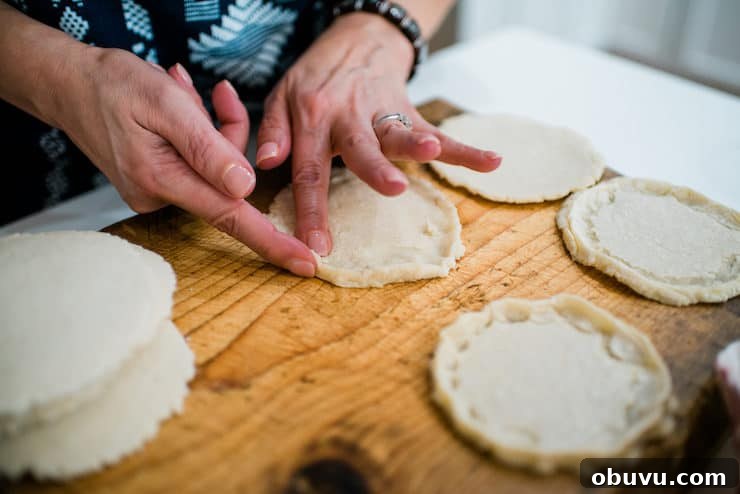 Brisket Sopes: Authentic Mexican Sopes de Carne Deshebrada 9 how to make sopes - showing hands pinching edge of sope as final step of sopes recipe.