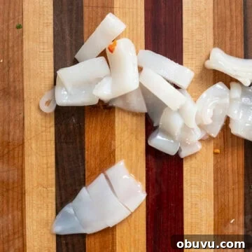 Black Squid Ink Pasta with Tender Calamari and Garlic Wine Sauce 4 Slicing squid tubes.