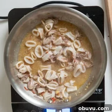 Black Squid Ink Pasta with Tender Calamari and Garlic Wine Sauce 7 Simmering calamari with garlic, chiles, and anchovies in white wine.