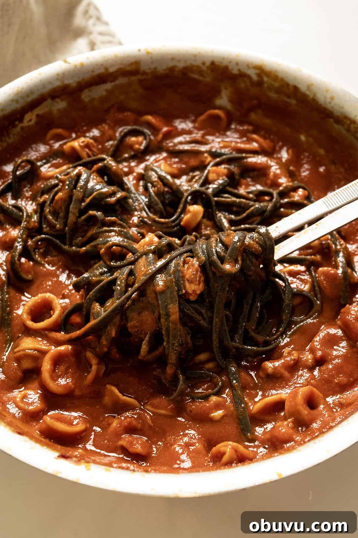 Black Squid Ink Pasta with Tender Calamari and Garlic Wine Sauce 10 Squid ink pasta with calamari in the pan.