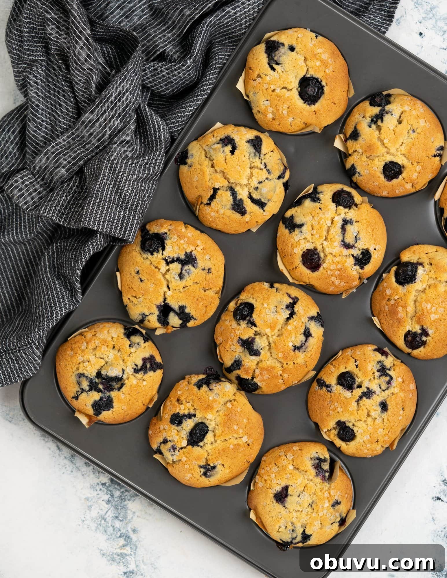Perfectly Moist Blueberry Muffins Recipe You’ll Make Again 4 Baked blueberry muffins with crunchy sugar on top.