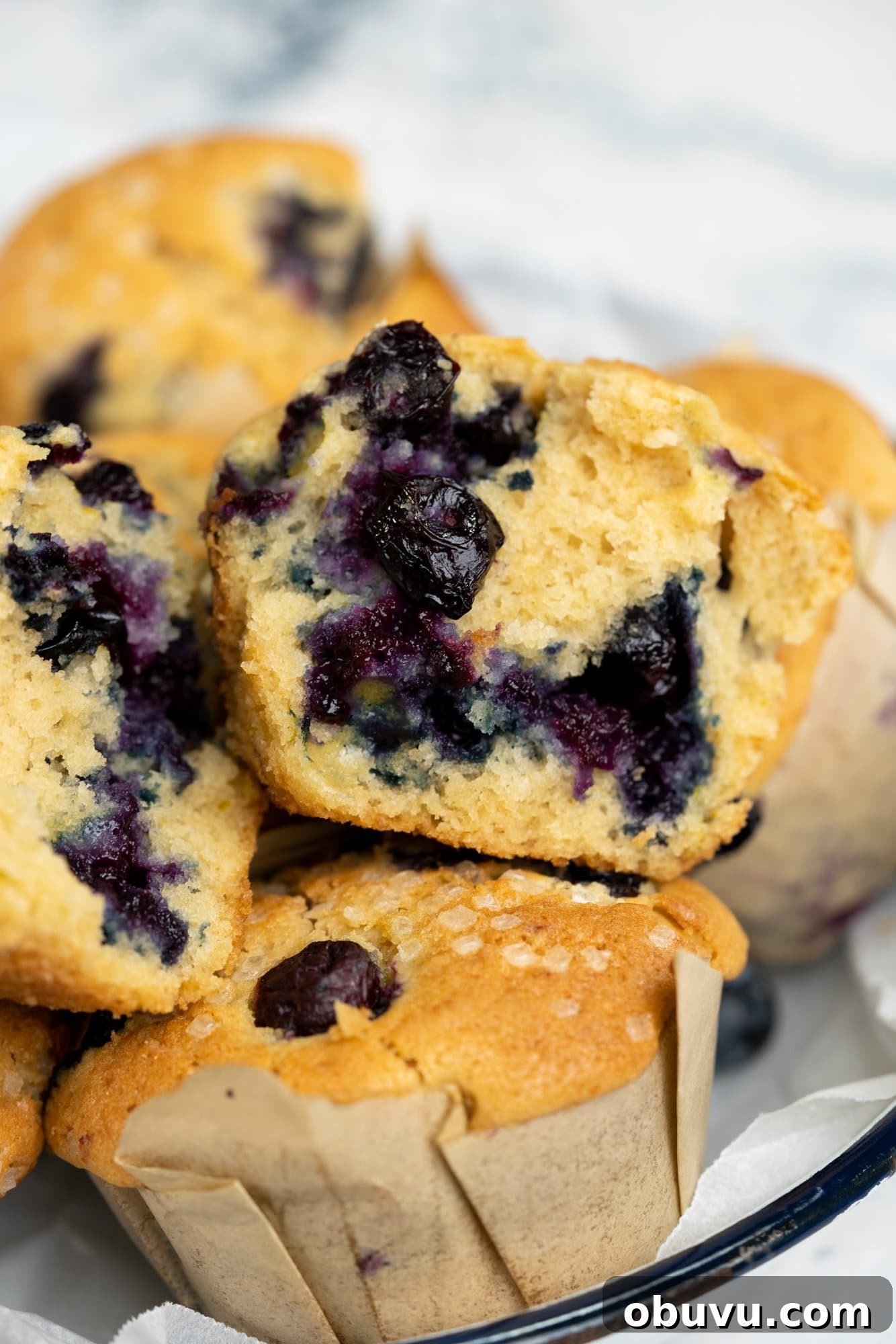 Perfectly Moist Blueberry Muffins Recipe You’ll Make Again 8 Cross section of a blueberry muffin showing the tender crumb and blueberries.