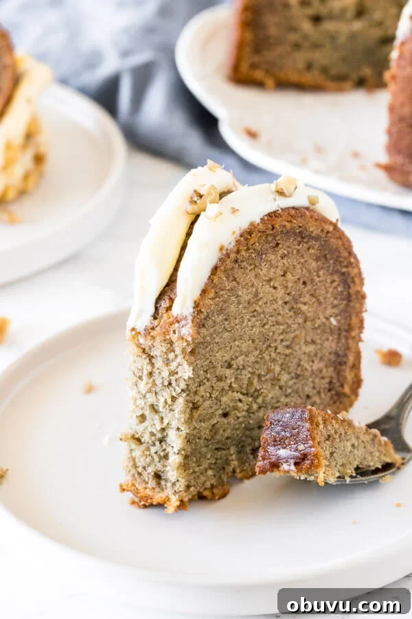 Moist Banana Bundt Cake Recipe for Perfectly Tender Loaf 5 A slice of banana cake with a bite taken out of it to show the moist, tender texture.