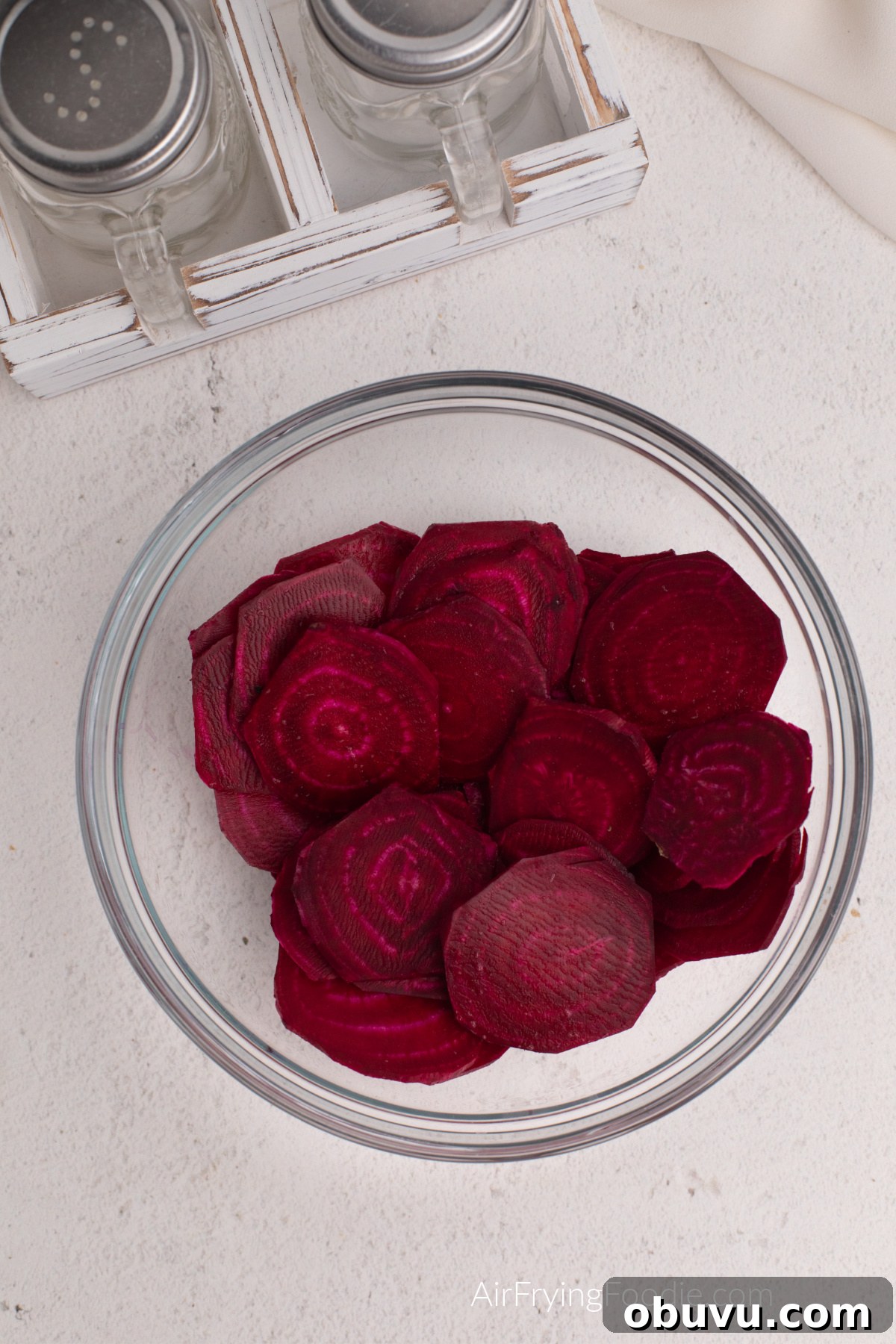 Crispy Air Fryer Beet Chips Recipe: Quick Homemade Snack 5 Beets sliced and covered in olive oil, salt, and pepper.