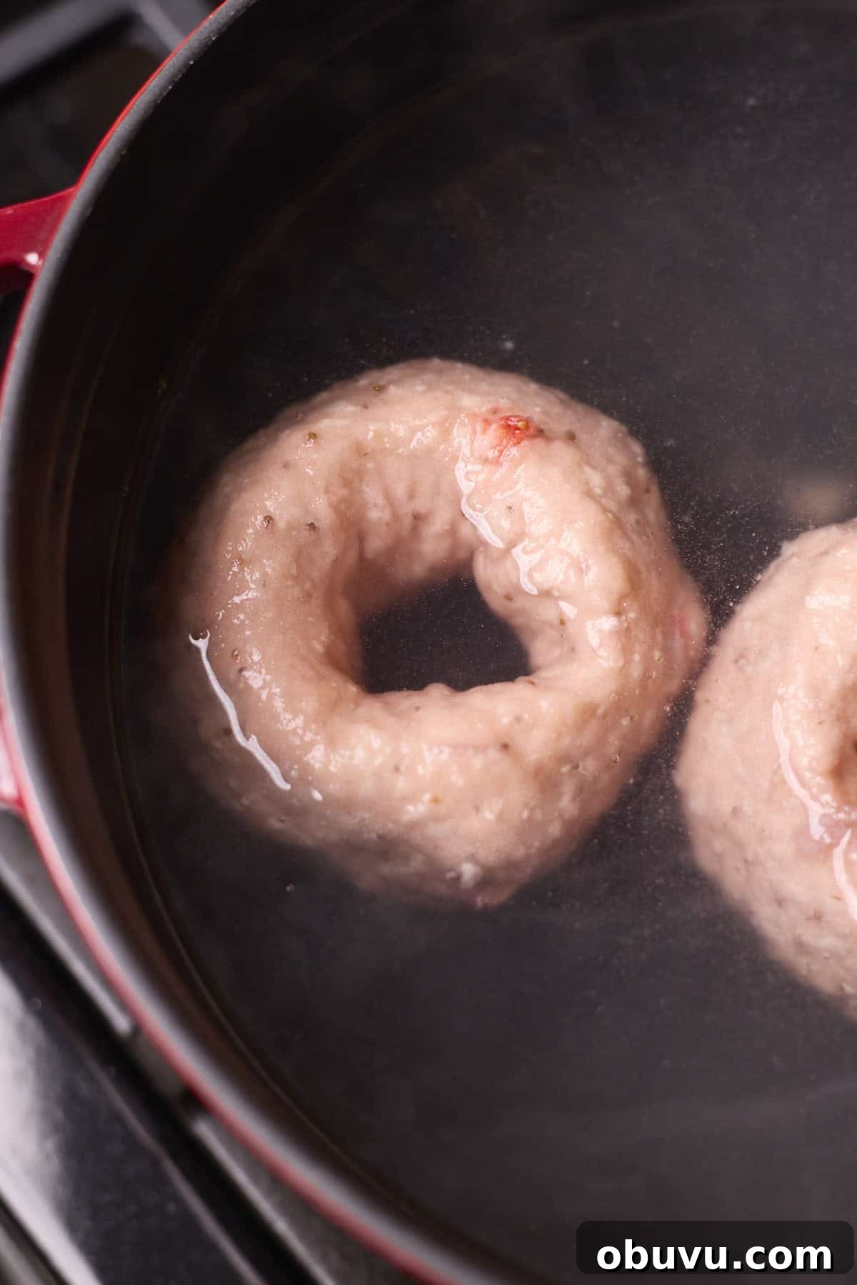 Strawberry Sourdough Discard Bagels: Soft, Tangy & Fresh 11 Bagels boiling in a pot of water.