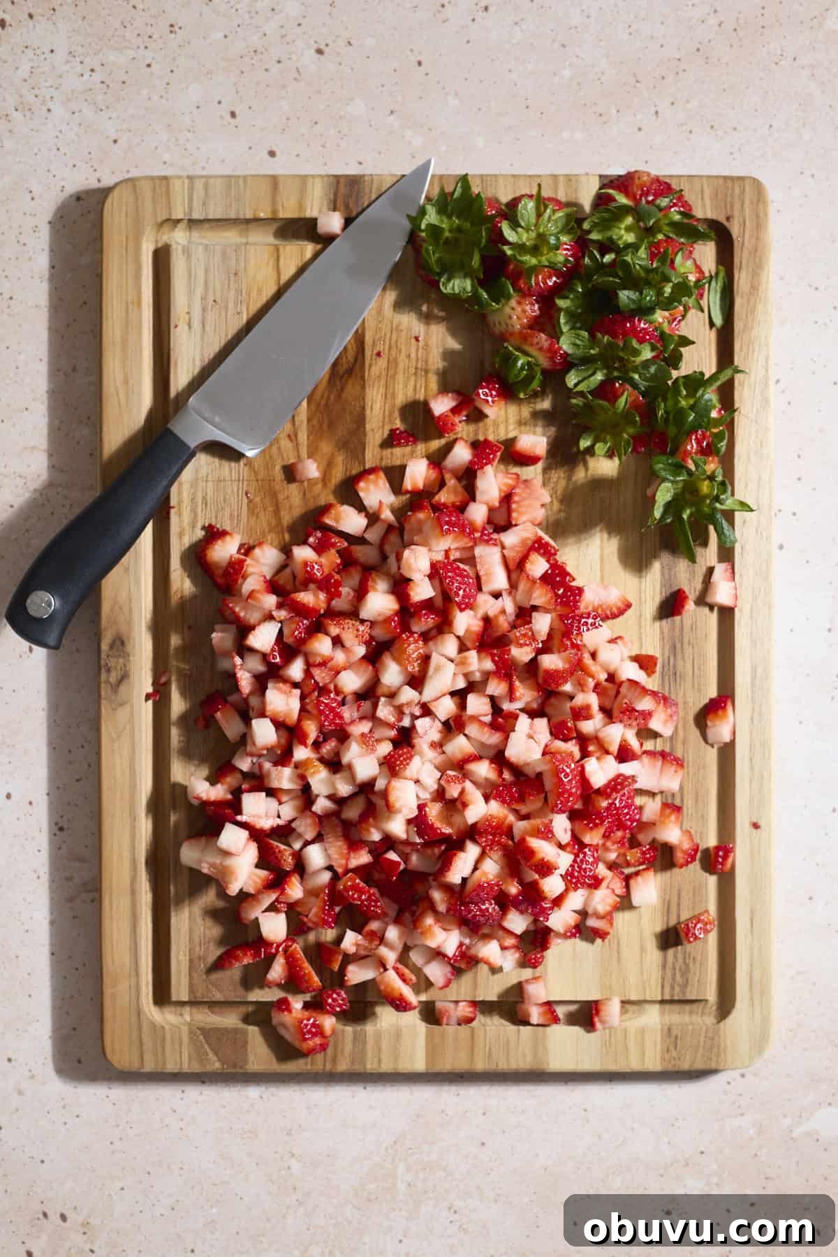 Strawberry Sourdough Discard Bagels: Soft, Tangy & Fresh 4 Strawberries diced on a wooden cutting board.