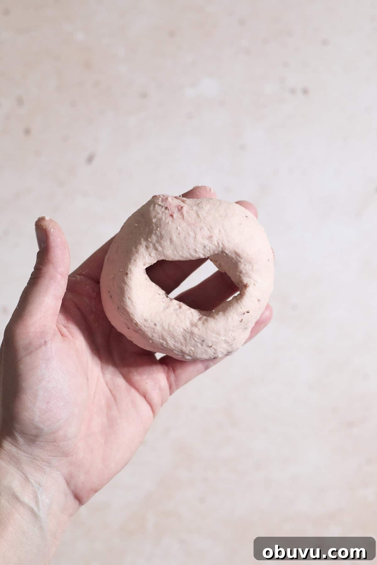 Strawberry Sourdough Discard Bagels: Soft, Tangy & Fresh 10 A bagel shaped in the palm of a hand.