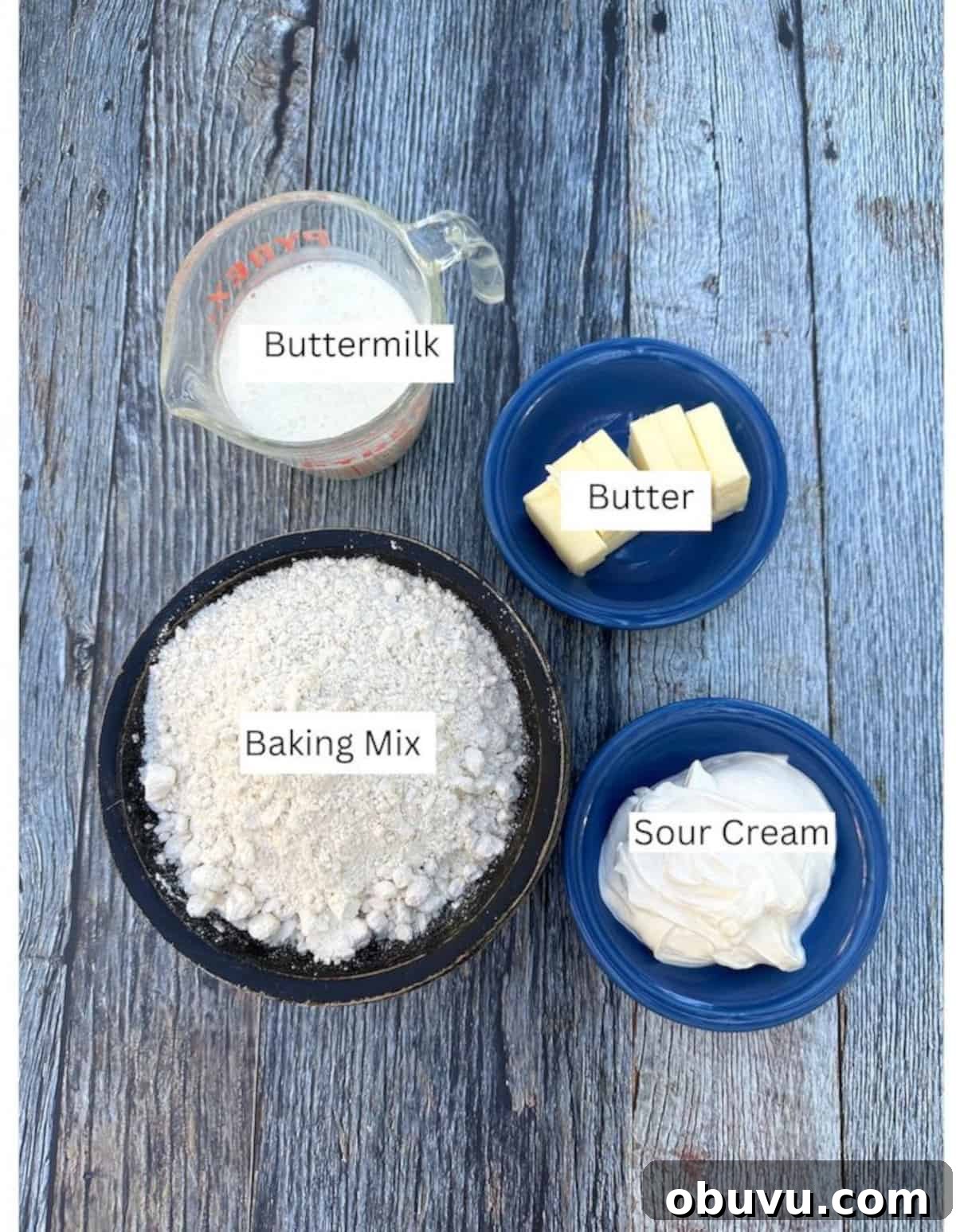 Flaky Buttermilk Biscuits Recipe for Perfect Homemade Biscuits 3 Ingredients for basic biscuits in containers arranged on a wooden plank.