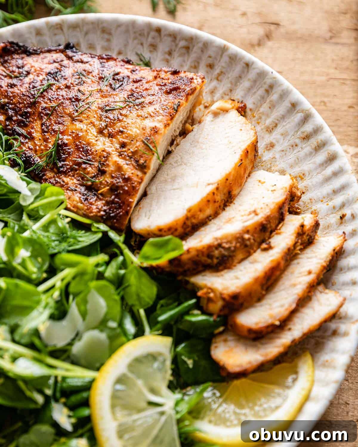 Air Fryer Boneless Skinless Frozen Chicken Breasts — Quick Juicy Results 6 Up close image of air fryer frozen chicken breasts with side salad and lemon.