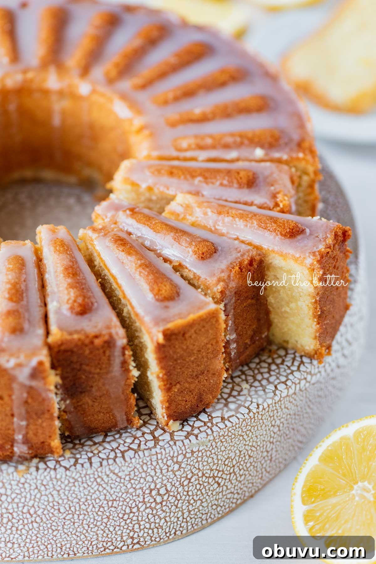 Lemon Cream Cheese Pound Cake Recipe with Zesty Glaze 9 Sliced lemon cream cheese pound cake with a lemon glaze on a cake stand