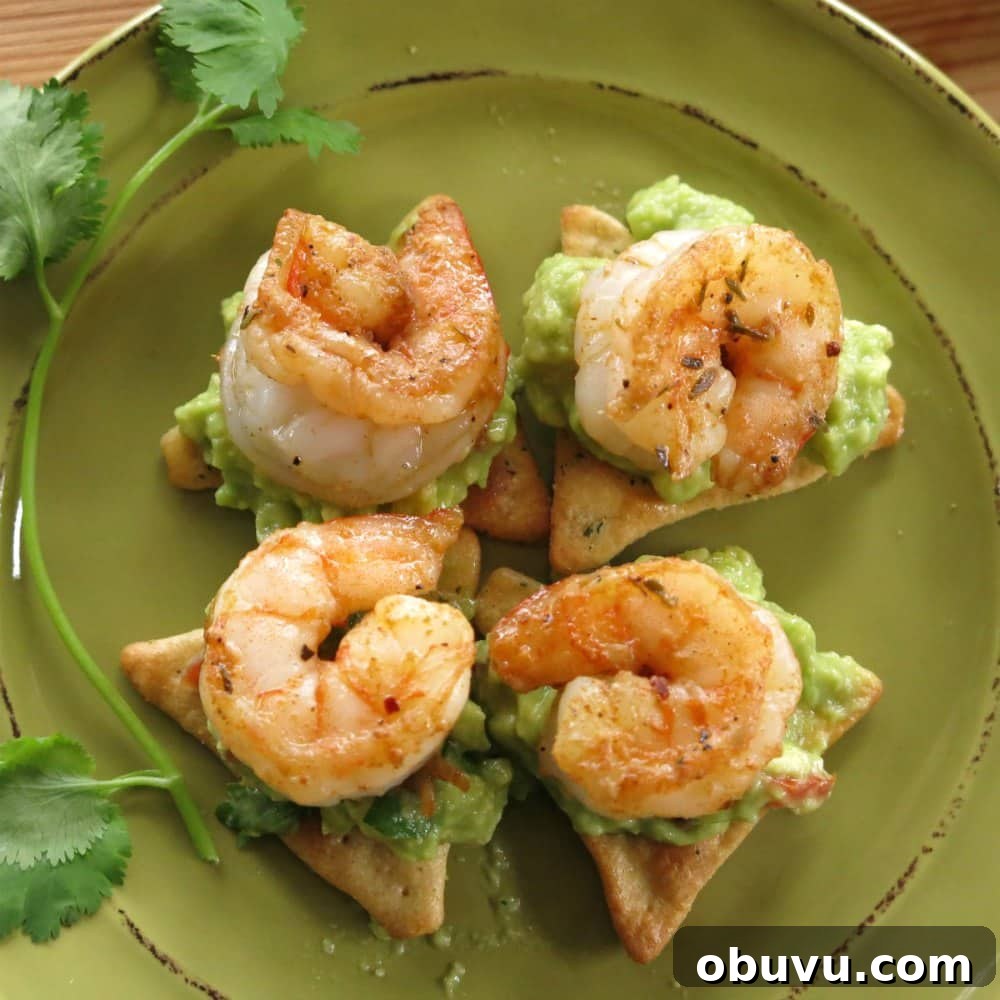 Cajun Shrimp Guacamole Bites: Spicy Shrimp Appetizer Recipe 5 4 pieces of shrimp and guacamole appetizer on plate.