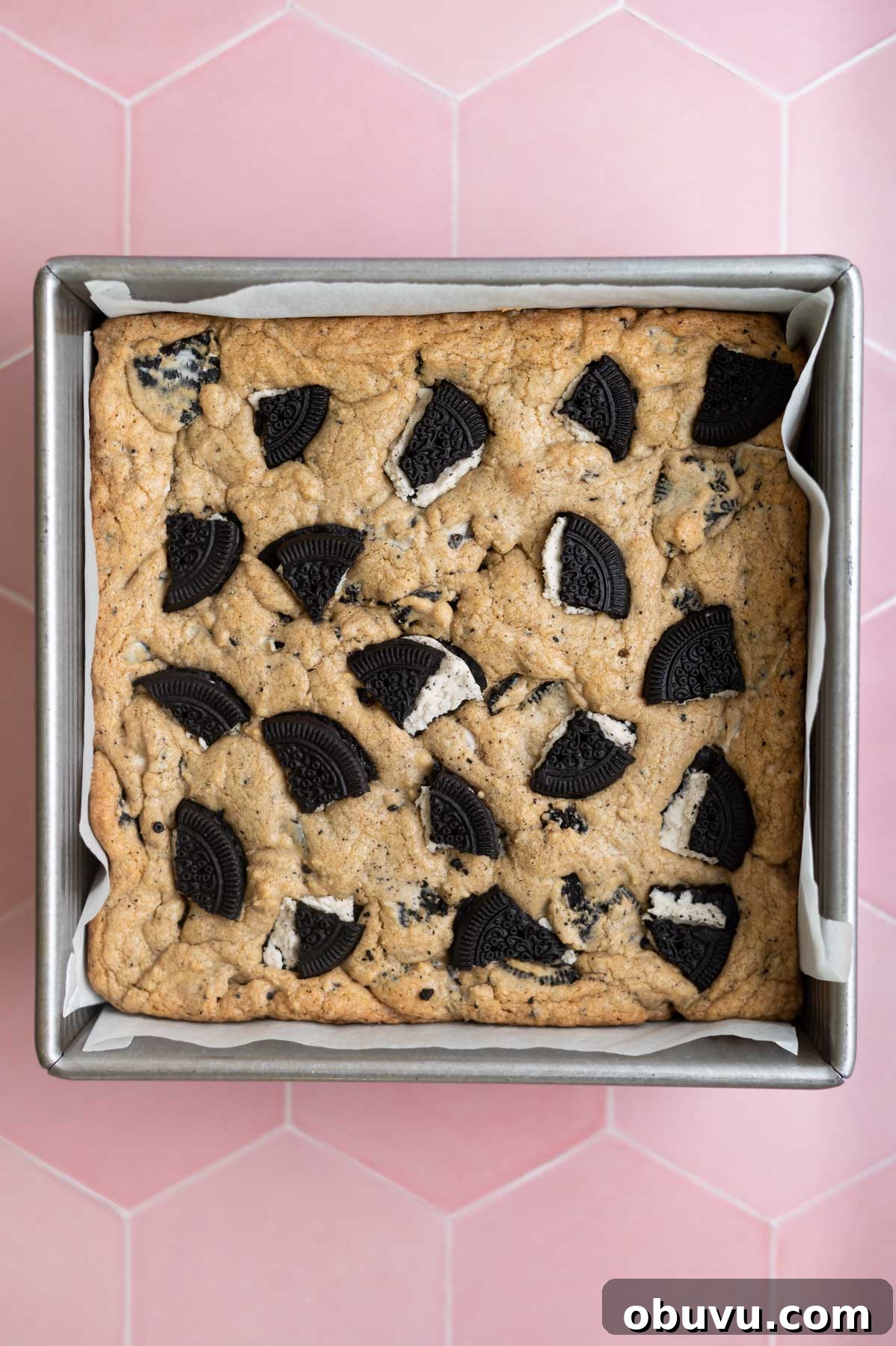 Soft Cookies and Cream Bars Recipe — Chewy & Irresistible 11 baked cookies and cream bars in a parchment lined baking pan