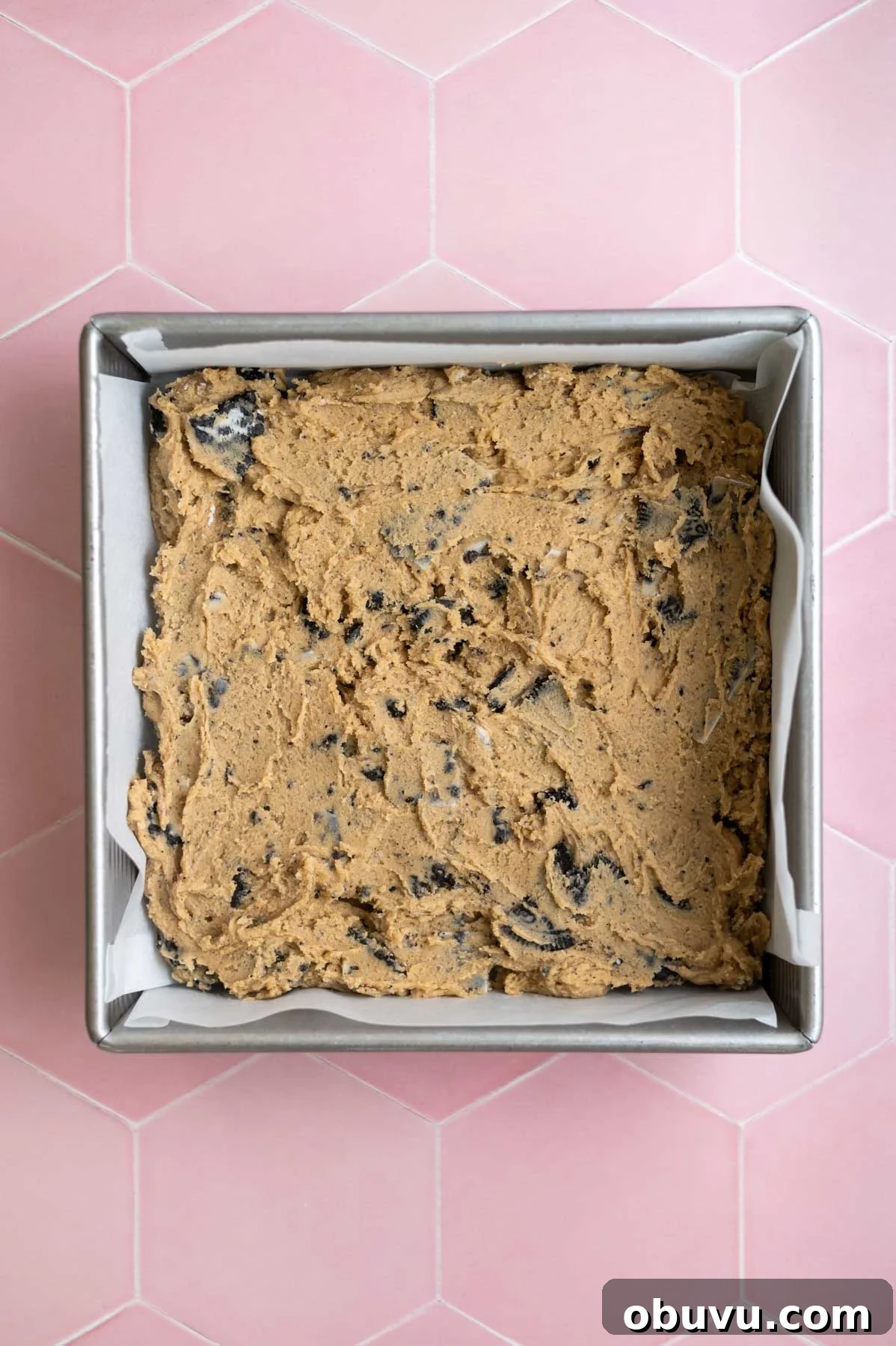 Soft Cookies and Cream Bars Recipe — Chewy & Irresistible 9 cookie dough pressed into a parchment lined baking tin