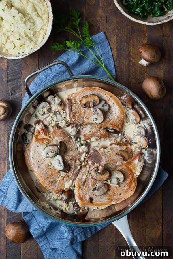 Garlic Butter Mushroom Pork Chops Without Canned Soup 3 Cream of mushroom pork chops in a pan with sides.