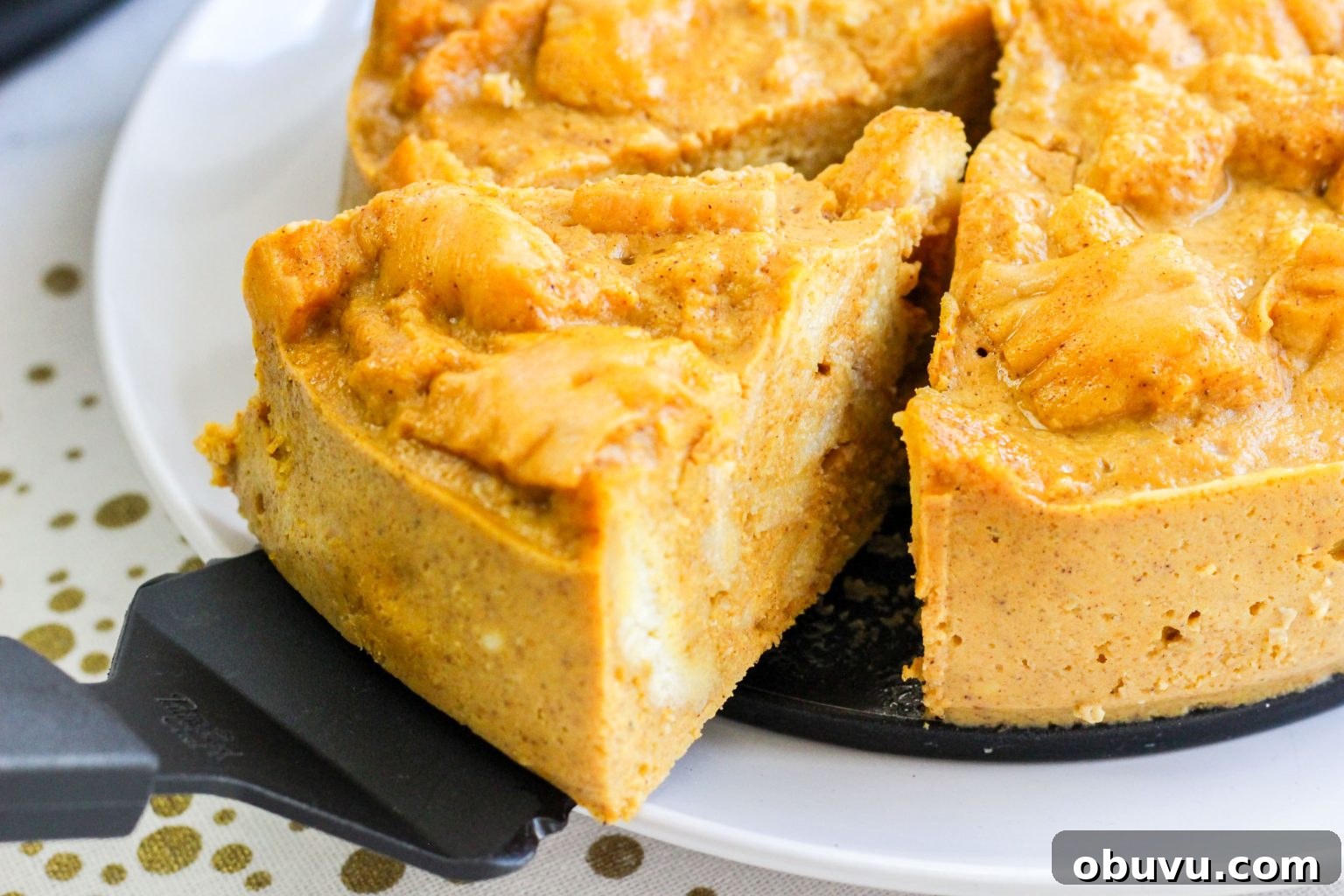 Instant Pot Pumpkin Bread Pudding with Air Fryer Crisp Option 2 Pumpkin Pie Bread Pudding Dessert with a piece being removed with a pie server.