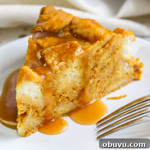 Instant Pot Pumpkin Bread Pudding with Air Fryer Crisp Option 12 A slice of pumpkin pie instant pot bread pudding on a plate with a fork sitting on it.