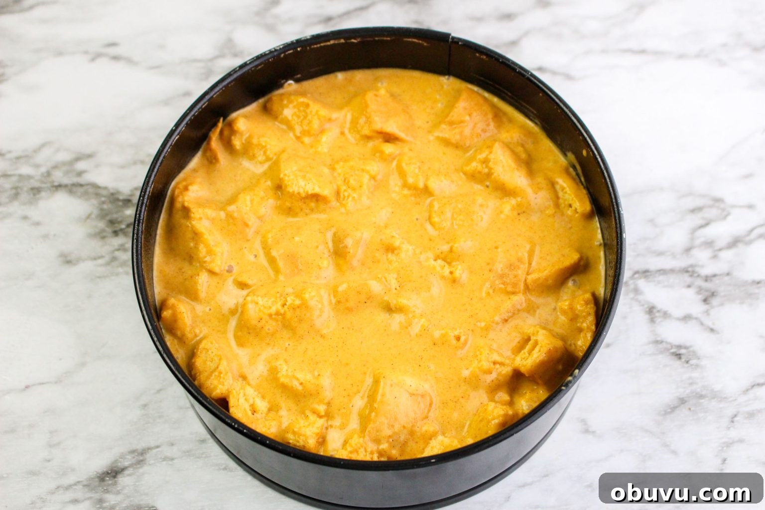 Instant Pot Pumpkin Bread Pudding with Air Fryer Crisp Option 6 A springform pan that's been filled with pumpkin bread pudding batter. Hostess At Heart