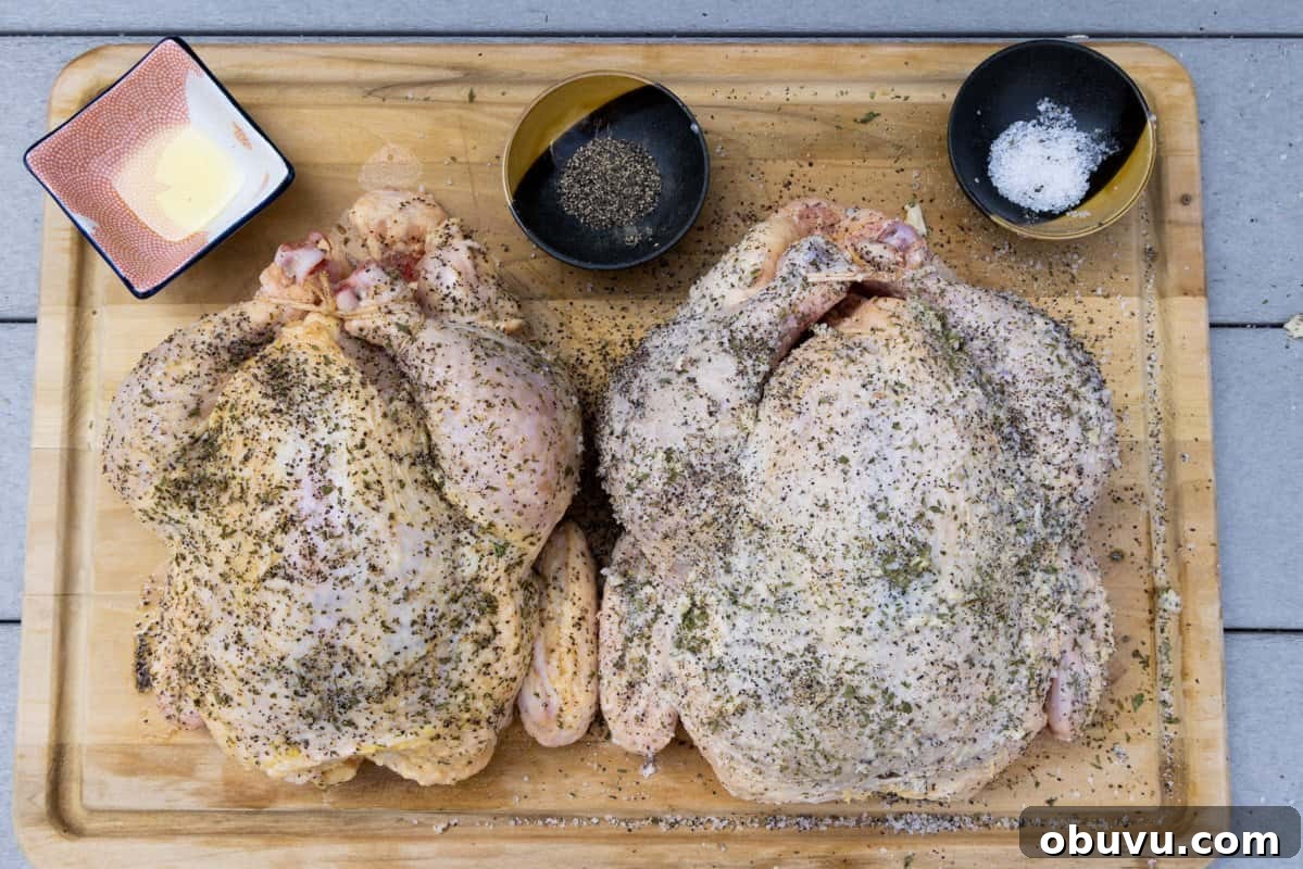 Smoked Whole Chicken Recipe: Juicy, Crispy Skin and Flavorful Smoke 5 Chickens on cutting board seasoned with salt, pepper, garlic, parsley and ready to be cooked