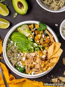Mexican street corn chicken and rice bowl topped with avocado, cilantro and tortilla chips