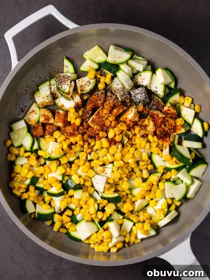 the corn and zucchini sautéed in a pan