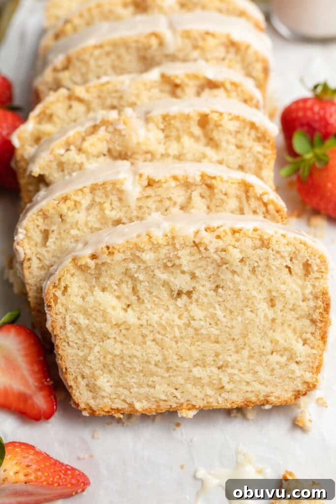 Ultimate Vegan Pound Cake Recipe You’ll Love 3 close up image of sliced vegan pound cake with strawberries on the side