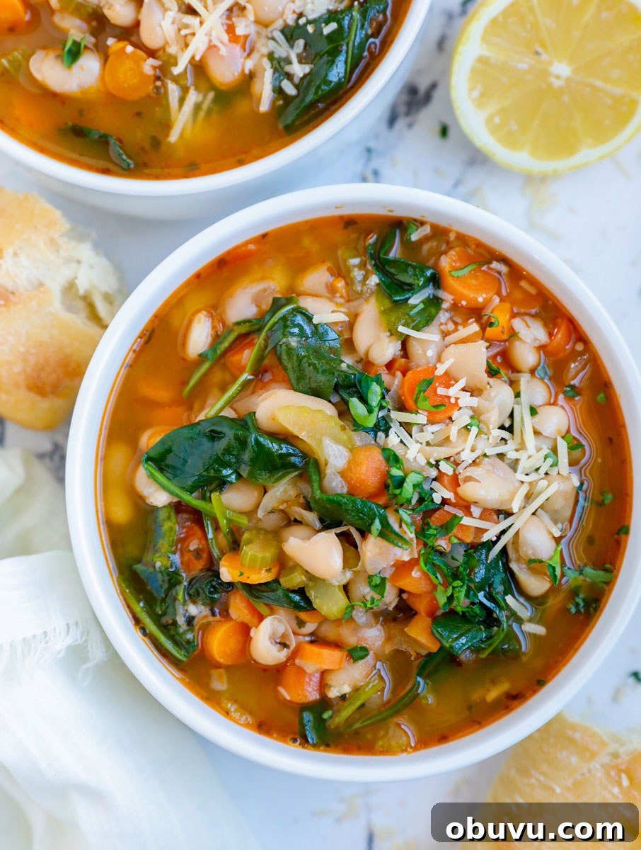 Authentic Tuscan White Bean Soup Recipe for Cozy Weeknights 9 Overhead photo of a bowl of white bean soup with bread beside it.