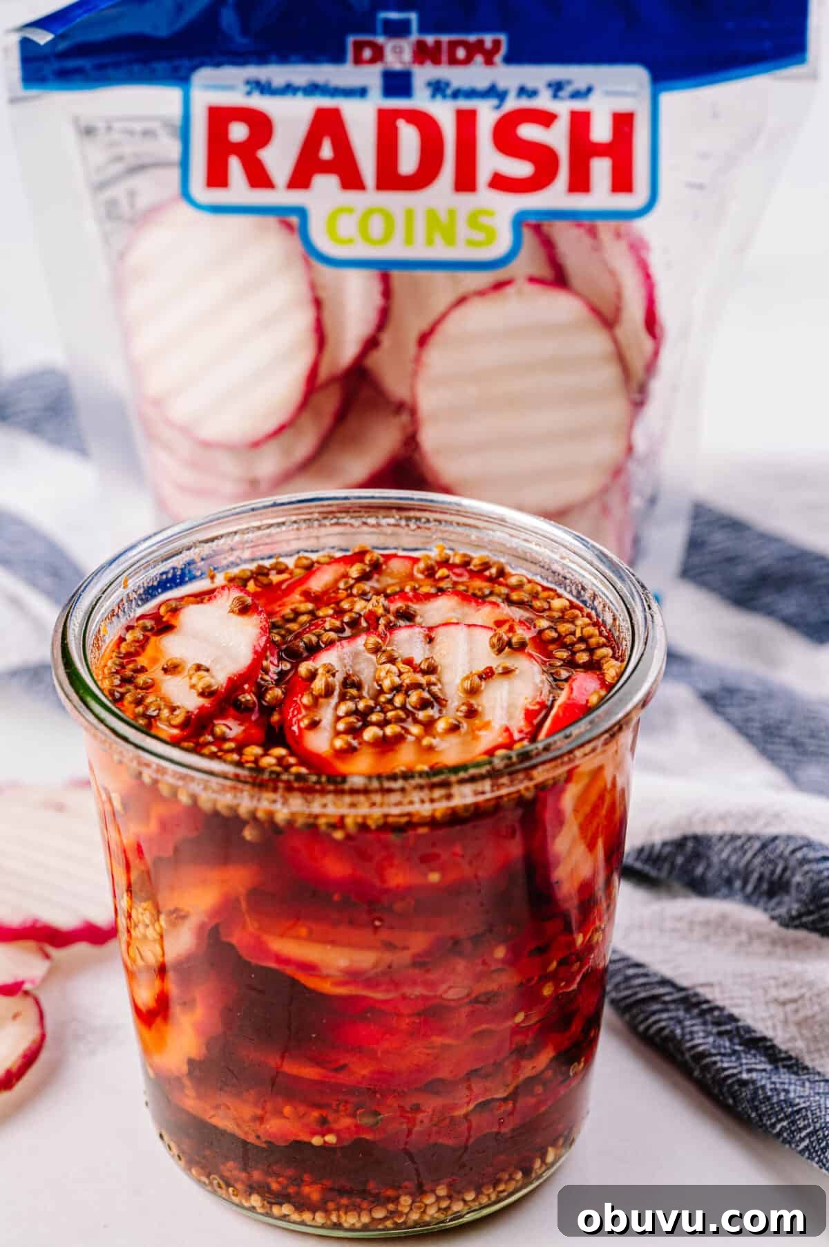 close up shot of pickled radishes in glass jar