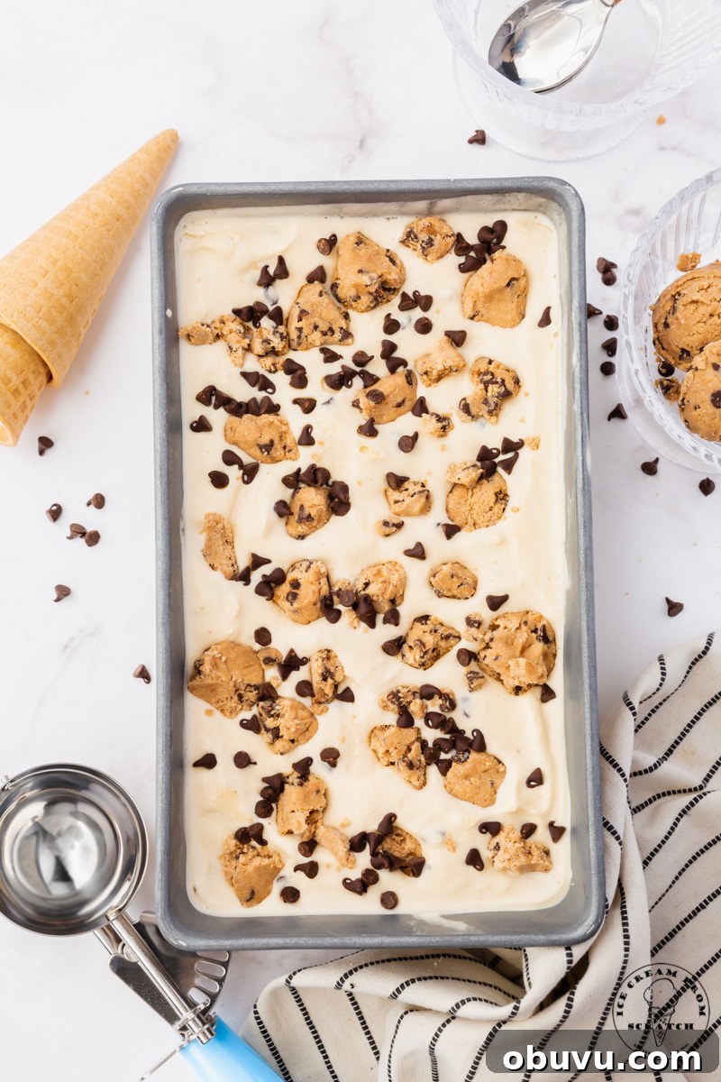 a loaf pan viewed from above, filled with homemade cookie dough ice cream with chocolate chips. 