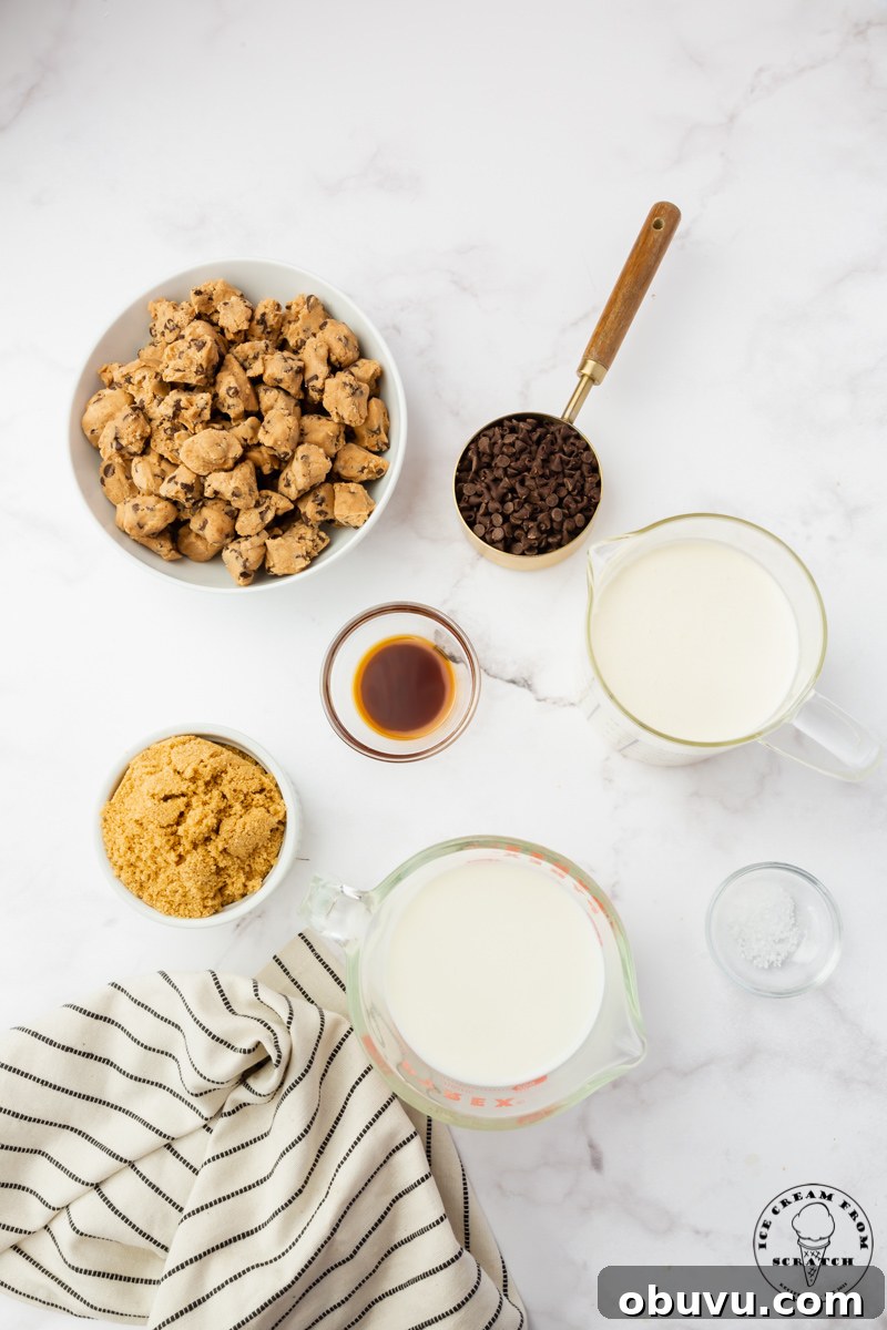 Ingredients needed for making cookie dough ice cream from scratch, all in separate bowls on a marble counter.