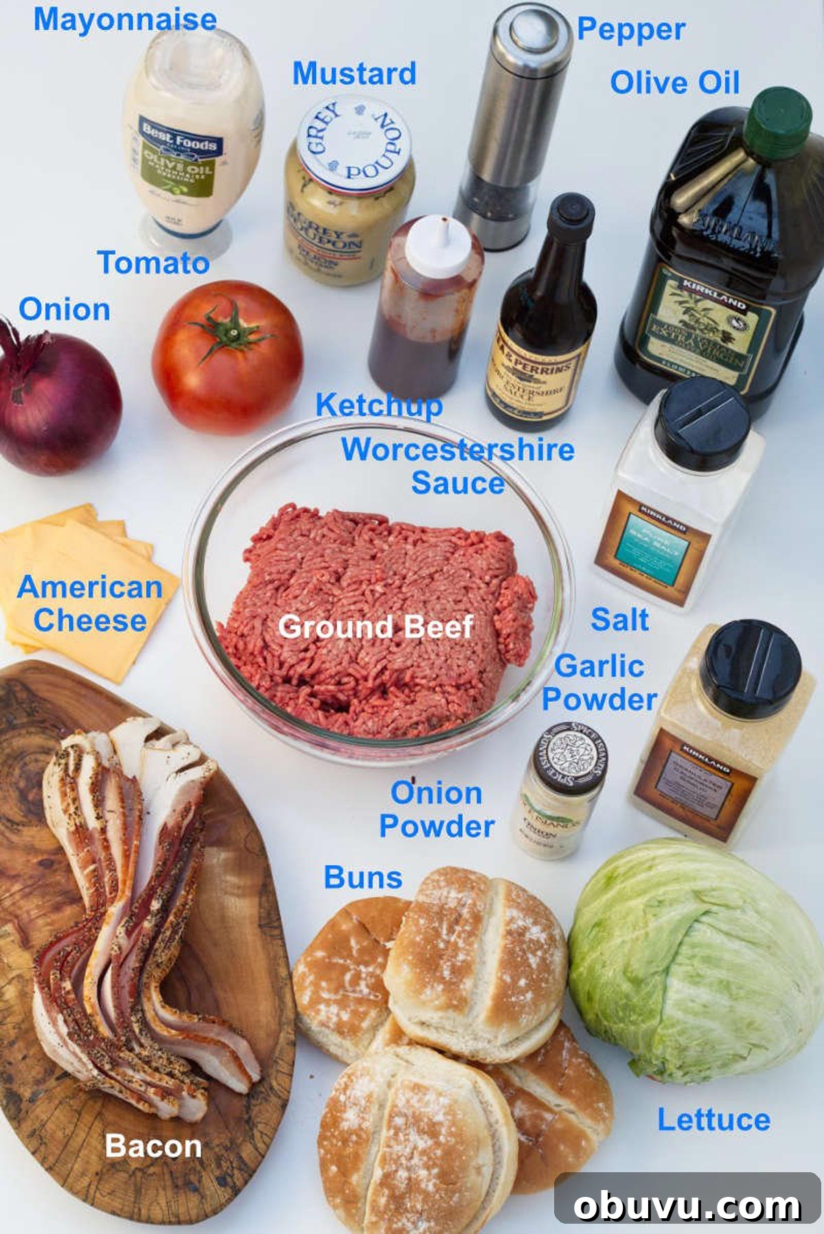 Juicy Lucy Burger Recipe: Melted Cheese-Stuffed Patties 4 Ingredients for a juicy lucy on a counter including ground beef, bacon, buns, lettuce, onion powder, garlic powder, american cheese.