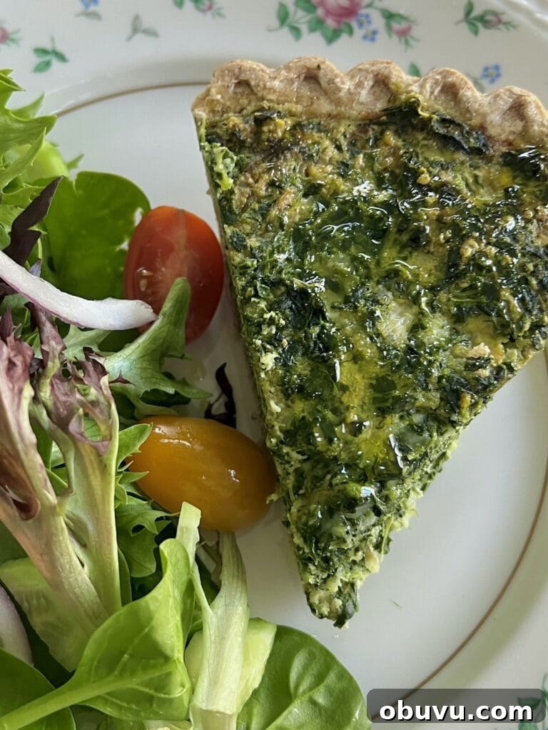 Spinach and Swiss Quiche with Frozen Pie Crust 10 Overhead view of slice of spinach quiche with frozen pie crust and mixed salad on dinner plate.