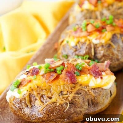 These are the Best Ever Baked Potatoes, from the prep work to the toppings, they're perfectly seasoned and loaded up with a creamy dressing, cheddar cheese, bacon, and chives!