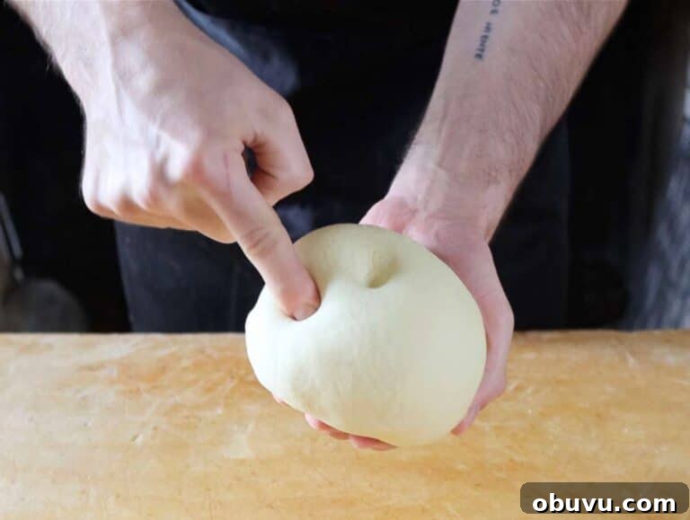 Handmade Trofie Pasta Recipe: Authentic Ligurian Method 11 Step 2 Kneading trofie pasta dough until smooth compact and elastic on wooden board.