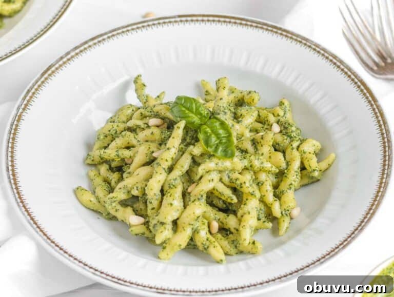 Handmade Trofie Pasta Recipe: Authentic Ligurian Method 14 Step 5 Cooked trofie pasta tossed in basil pesto and served in a gold-rimmed pasta plate