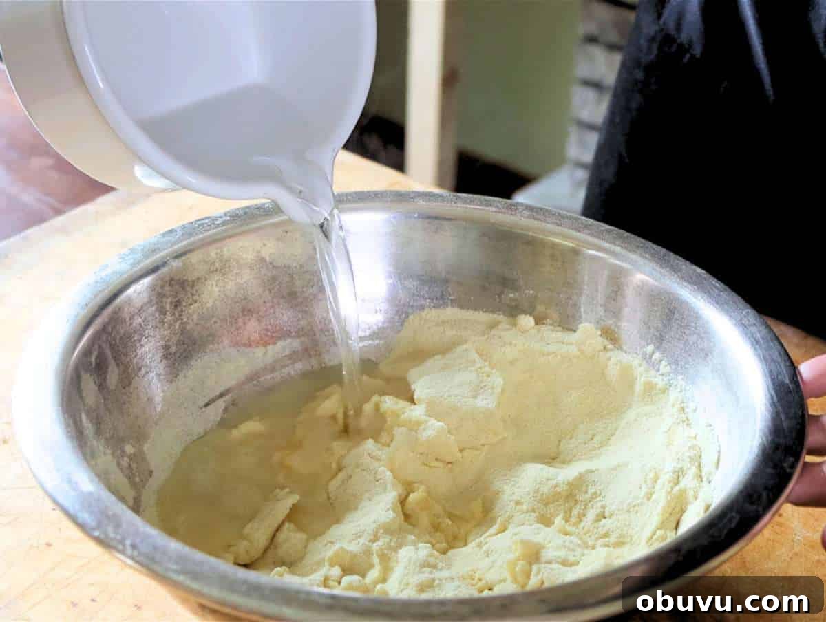Handmade Trofie Pasta Recipe: Authentic Ligurian Method 4 Step 1 Mixing semolina flour and water in a bowl for trofie pasta dough.