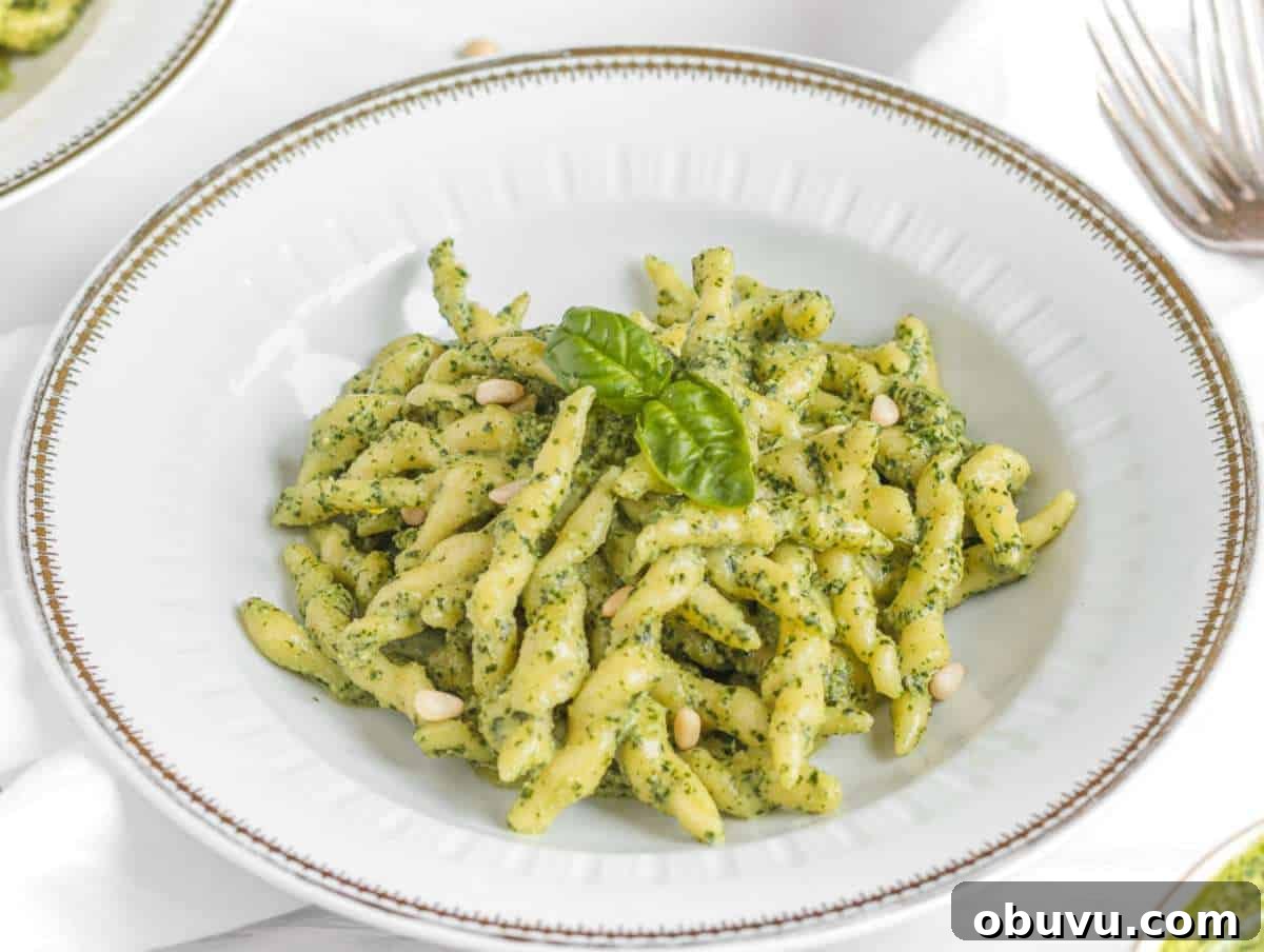 Handmade Trofie Pasta Recipe: Authentic Ligurian Method 8 Step 5 Cooked trofie pasta tossed in basil pesto and served in a gold-rimmed pasta plate