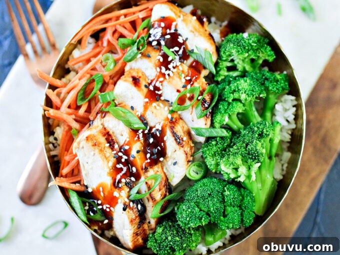 General Tso Grilled Chicken Bowls with Sesame Rice 2 grilled chicken, broccoli and carrots in a bowl with General Tso's chicken sauce.