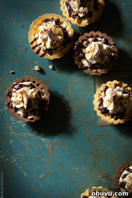 Mini Snickers Tartlets: Salted Caramel Peanut Chocolate Bites 3 A fast and simple party dessert: Snickers Tartlet via Bakers Royale