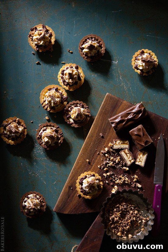 Mini Snickers Tartlets: Salted Caramel Peanut Chocolate Bites 4 A fast and simple party dessert: Snickers Tartlet via Bakers Royale