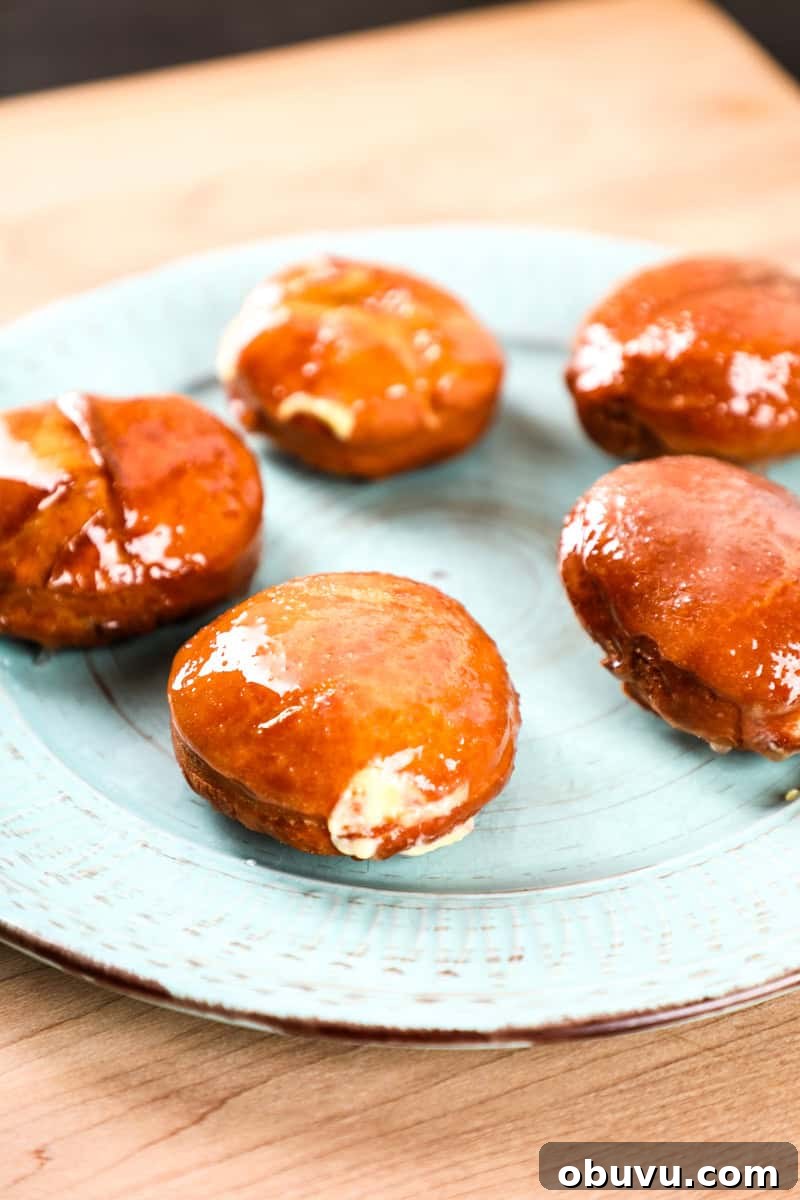 Crème Brûlée-Filled Donuts: Decadent Custard-Packed Treats 5 5 doughnuts on a plate with vanilla cream filling and a creme brulee topping.
