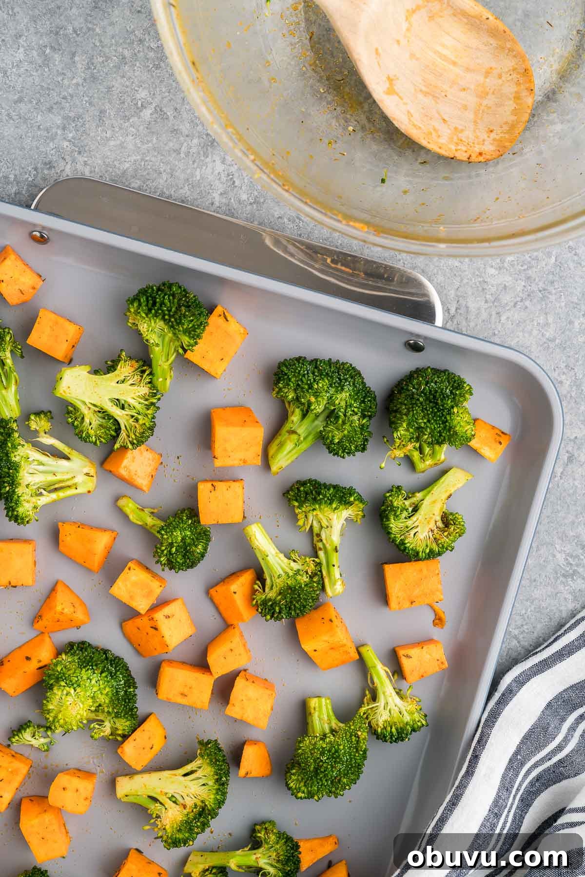 Crispy Roasted Broccoli with Maple-Sweet Potatoes 5 broccoli florets and sweet potatoes on a sheet pan