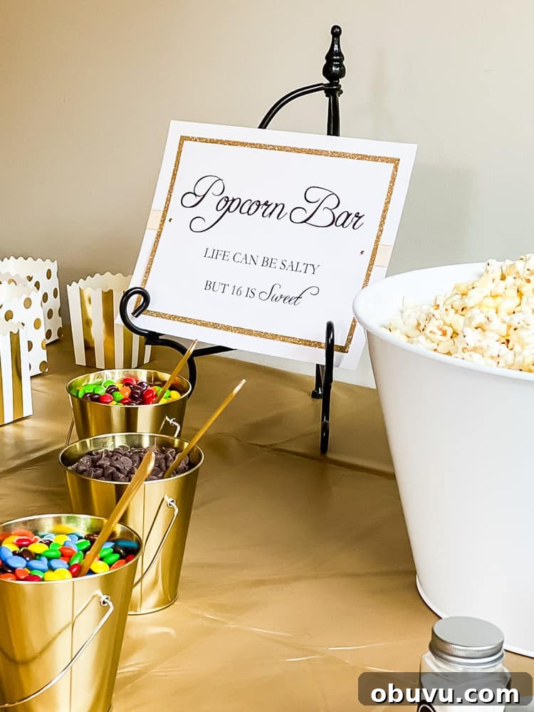 popcorn bar sign on metal easel with small buckets filled with candy in front and big tub of popcorn on side of sign