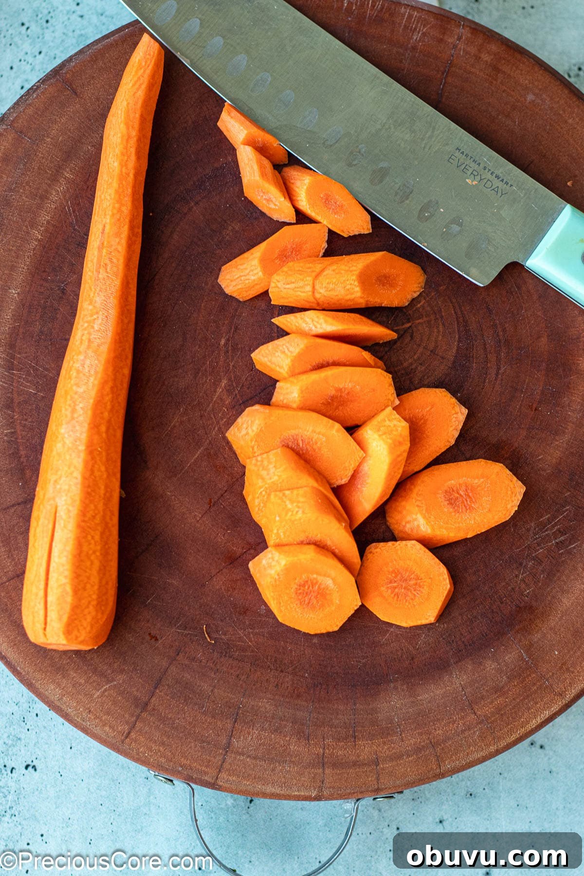 Crispy Pan-Fried Carrots with Garlic and Herbs 4 Diagonally cut carrots on a chopping board.
